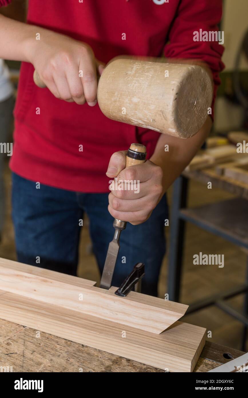 Carpenter Works In Workshop With Wooden Hammer And Chisel - Craftsman ...