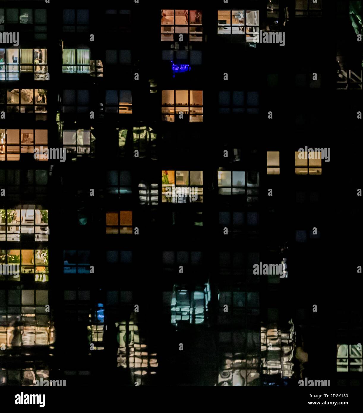 Detail image of several floors of a NYC apartment building at night Stock Photo