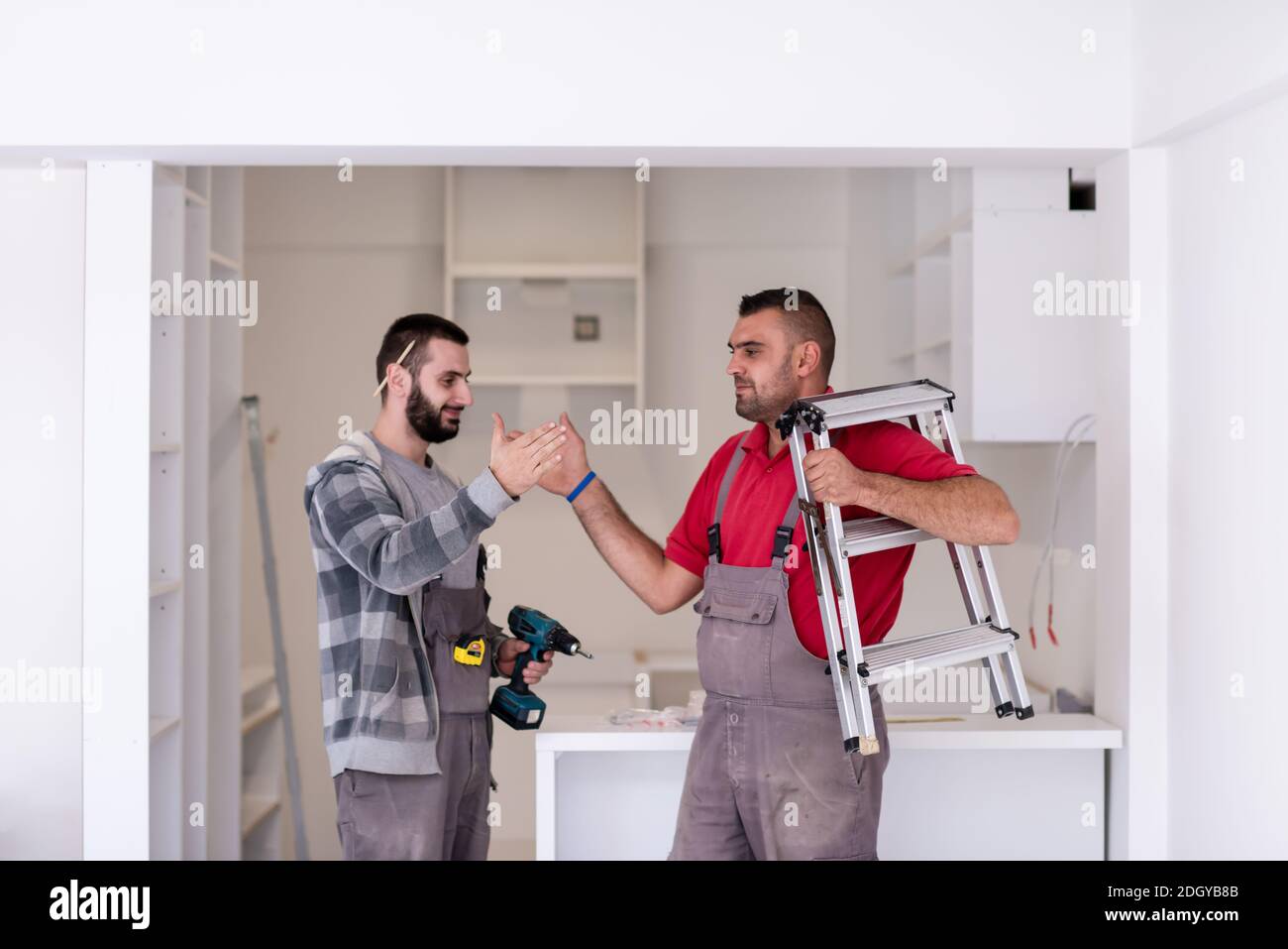 Workers giving high five to each other Stock Photo - Alamy