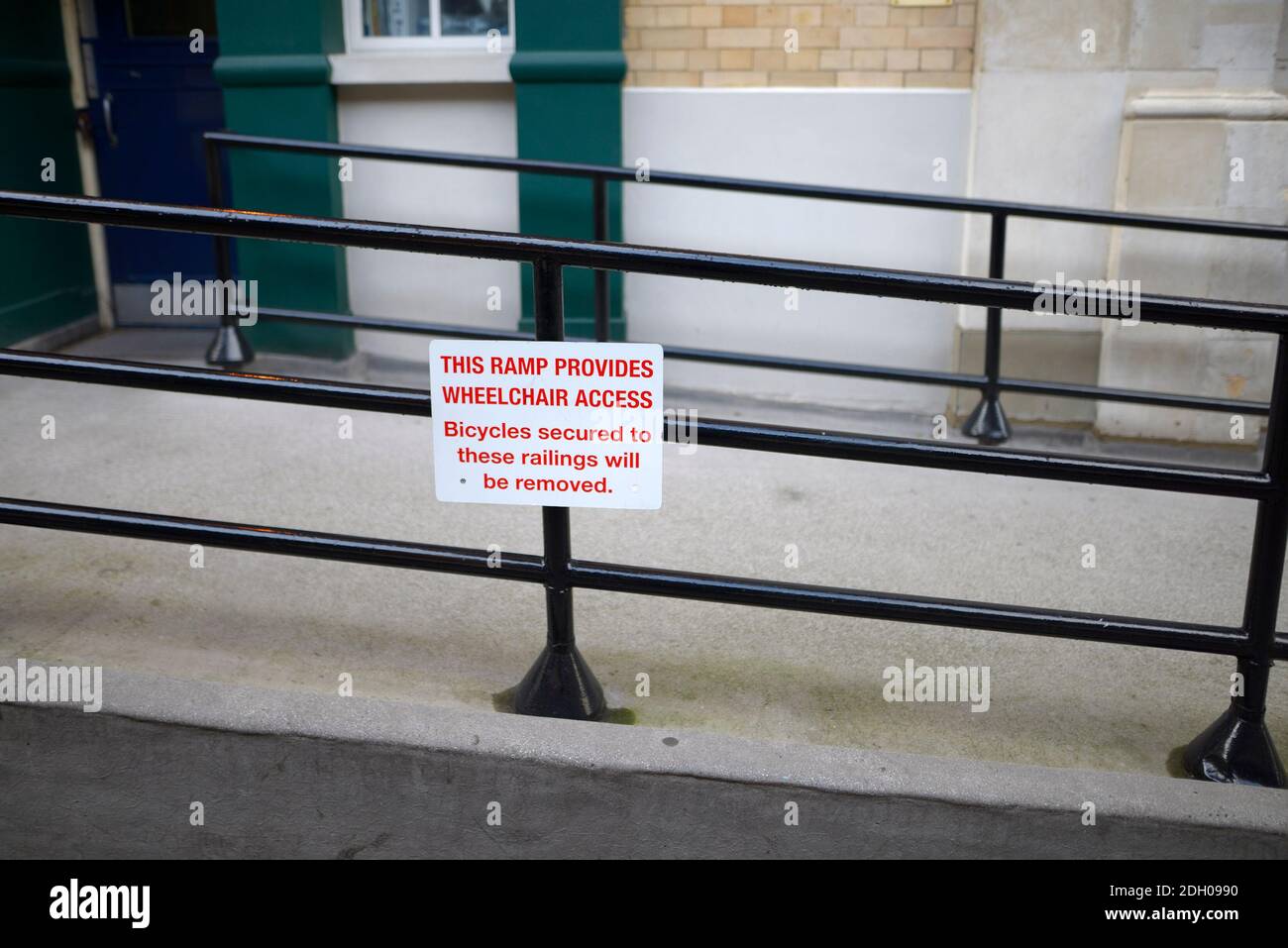 London, England, UK. Wheelchair ramp in Covent Garced, with sign warning againts chaining bikes to the railings Stock Photo