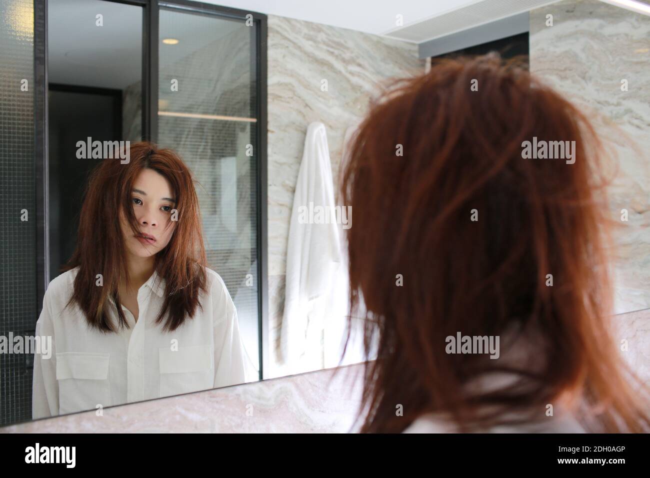 woman watch herself in bathroom Stock Photo Alamy
