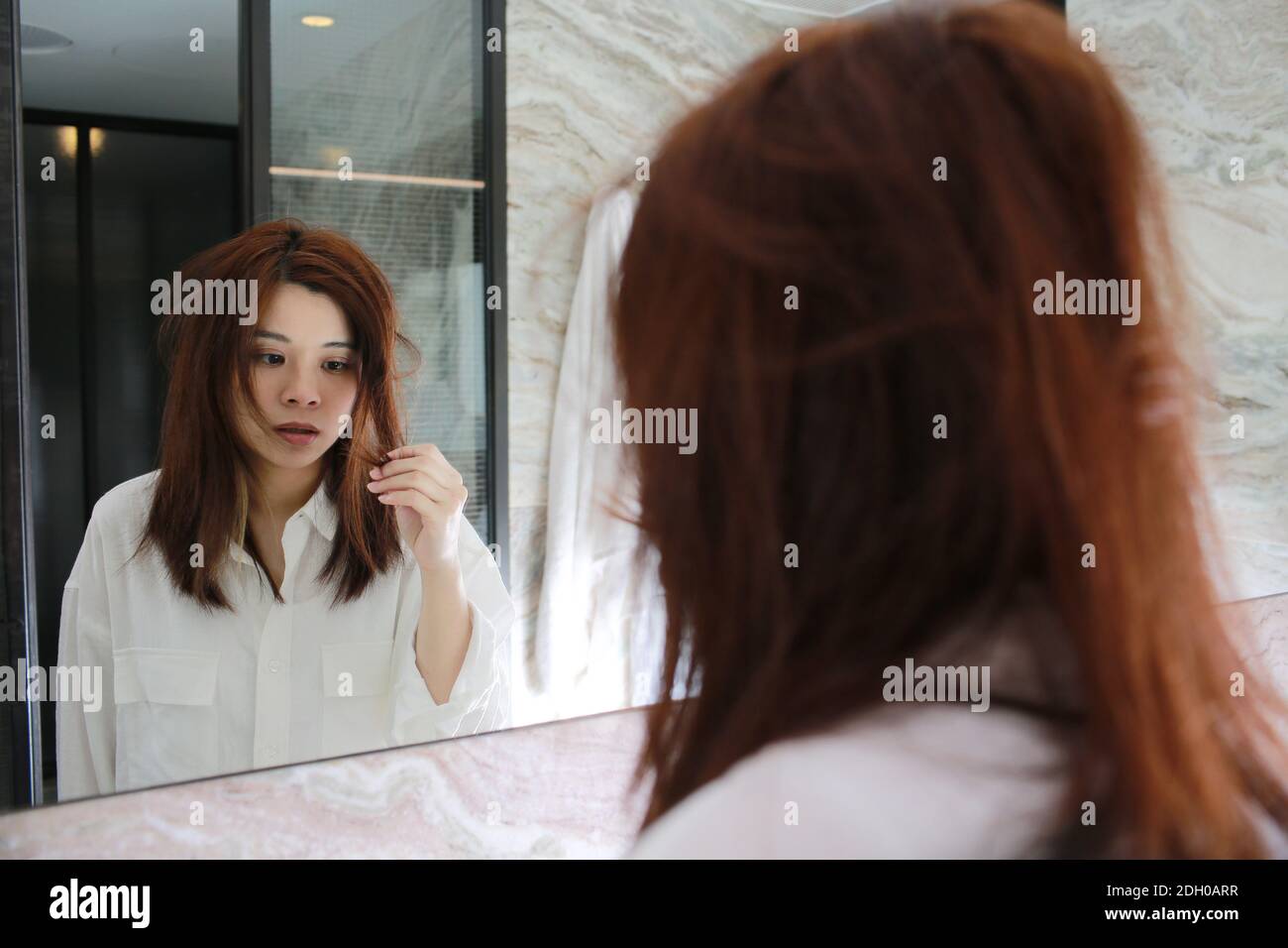 woman watch herself in bathroom Stock Photo Alamy