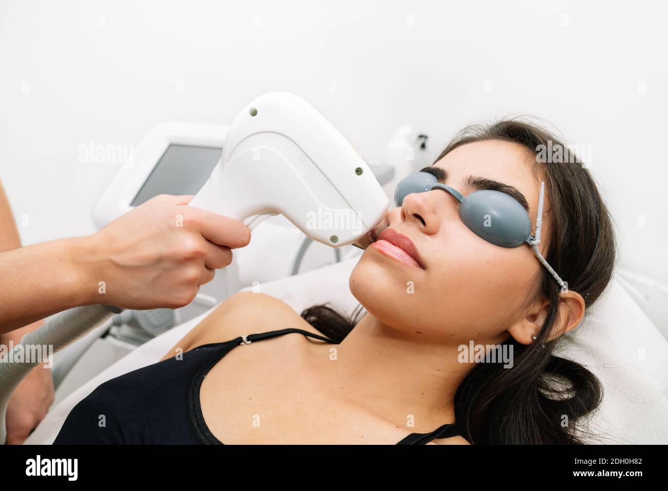 Short shot of beautician giving laser diode treatment to a woman with a  moustache where the client is wearing laser protection glasses Stock Photo  - Alamy