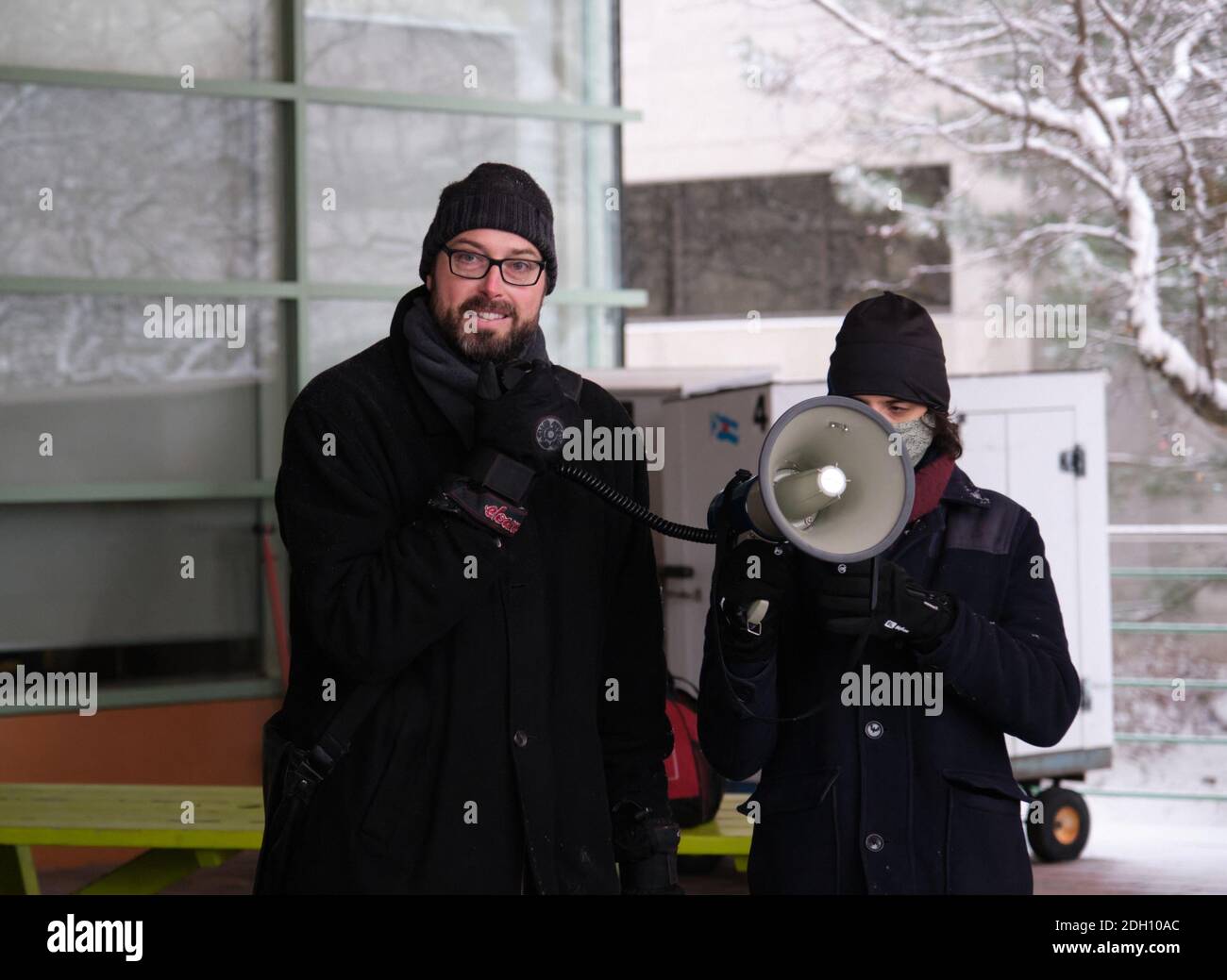 Ottawa, Canada. December 9th, 2020. City Councillor Shawn Menard speaking with representative from various community groups protesting against the 2021 city budget citing that in fails to address multiple crises. Menard is putting is ongoing support to the demands of the group. The group specifically argues against increase in police budget, and the bailout of the OSEG sports group, over needed community support badly hit by the ongoing pandemic. Credit: meanderingemu/Alamy Live News Stock Photo