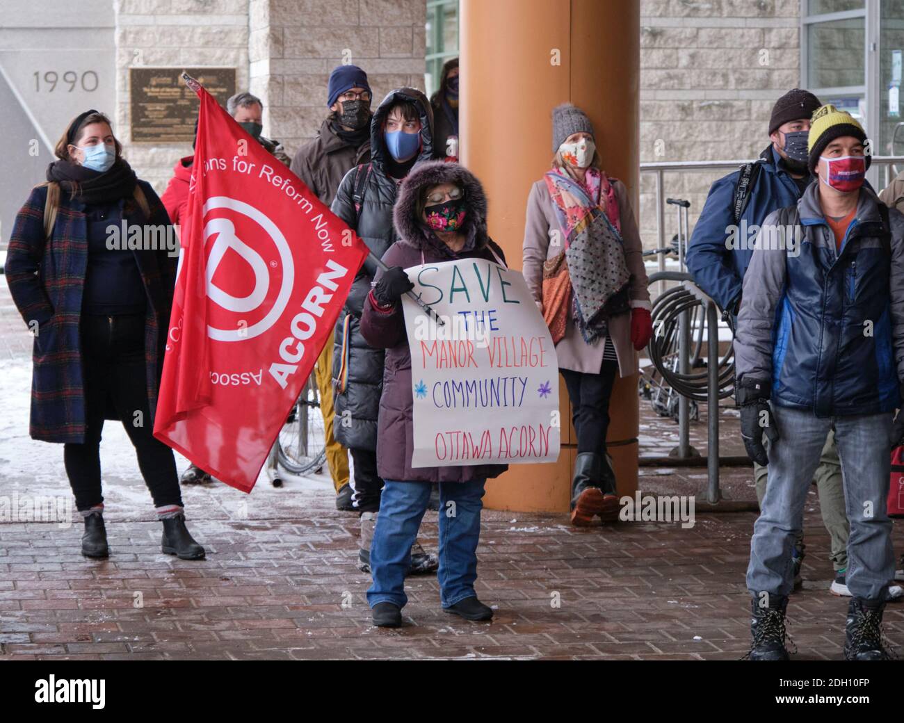 Ottawa, Canada. December 9th, 2020. Member of the ACORN group demanding to save the Manor village Community phased for destruction due to transit expansion. Representative from various community groups protest against the 2021 city budget citing that in fails to address multiple crises. The group specifically argues against increase in police budget, and the bailout of the OSEG sports group, over needed community support badly hit by the ongoing pandemic. Credit: meanderingemu/Alamy Live News Stock Photo