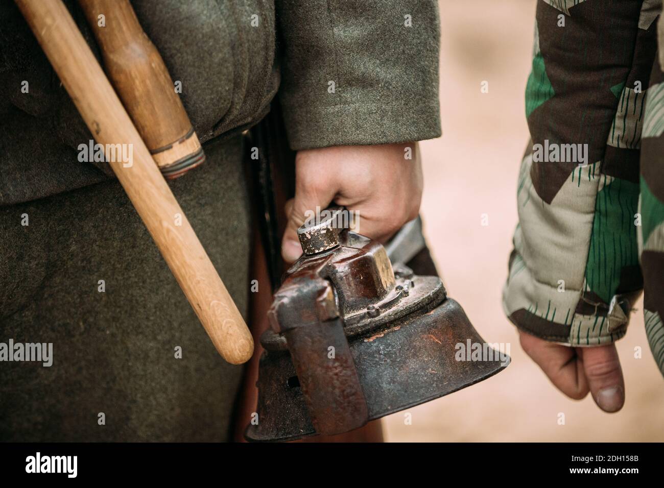 Close Up Of German Military Ammunition Of A German Wehrmacht Soldier. Re-enactor Dressed As World War II German Soldiers Holding Handy Siren, Alarm Stock Photo