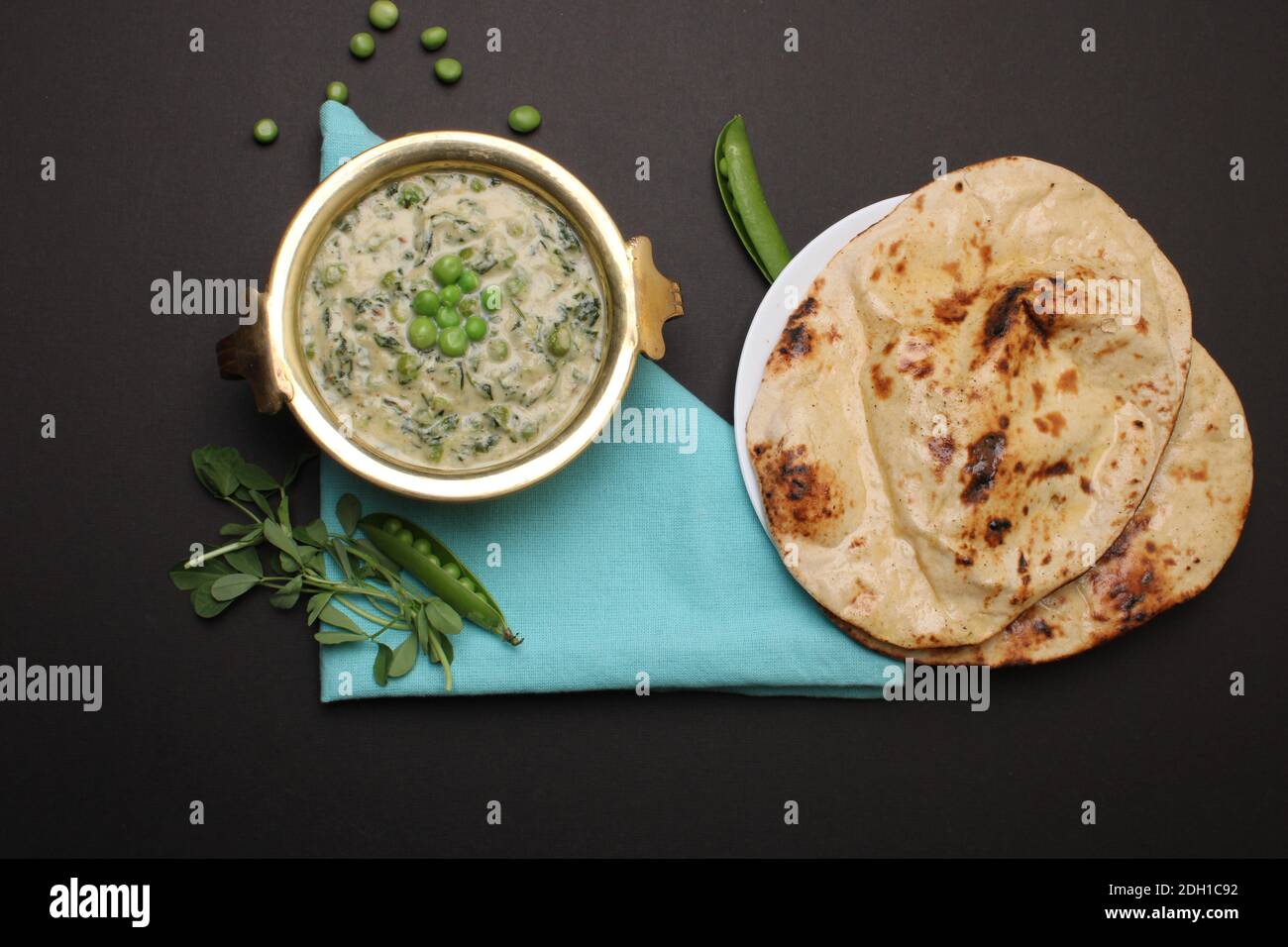 Methi Mutter Malai, Indian food server with naan or tandoori roti. Stock Photo