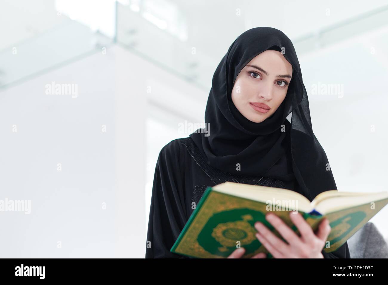 Young muslim woman reading Quran at home Stock Photo - Alamy