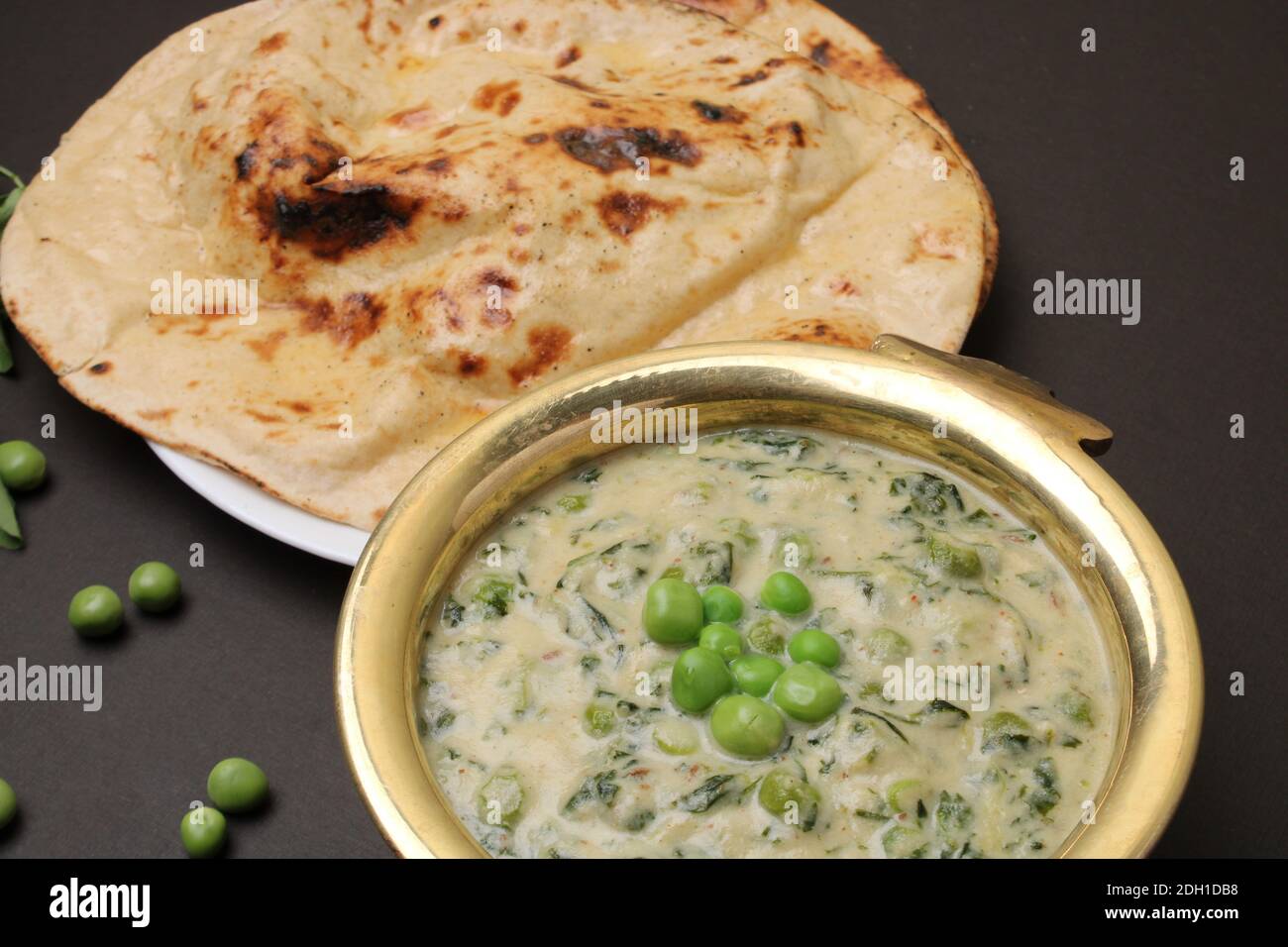 Methi Mutter Malai, Indian food server with naan or tandoori roti. Stock Photo