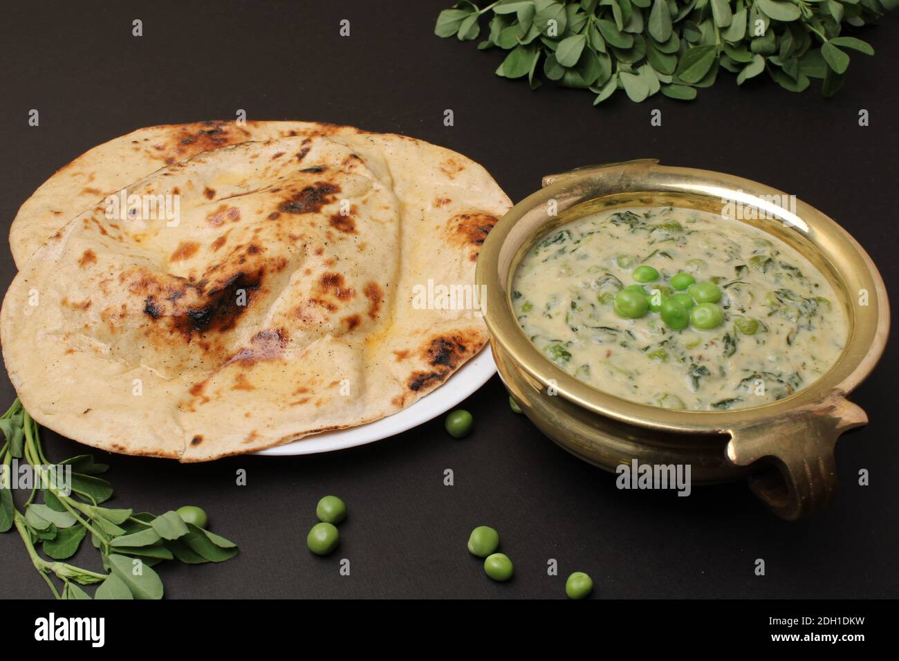 Methi Mutter Malai, Indian food server with naan or tandoori roti. Stock Photo