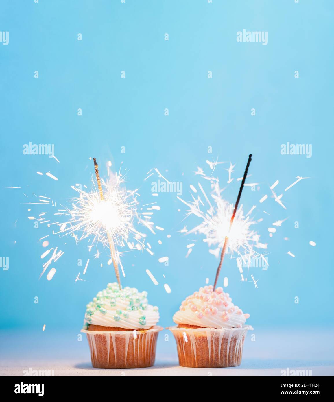 Two cupcakes decorated with sparklers, copy space Stock Photo