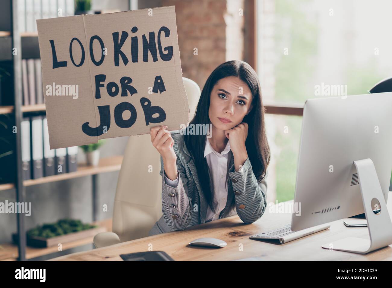 Photo of sad frustrated upset girl marketer financier agent sit desk hold cardboard text look for job have dismissed from company crisis recession Stock Photo