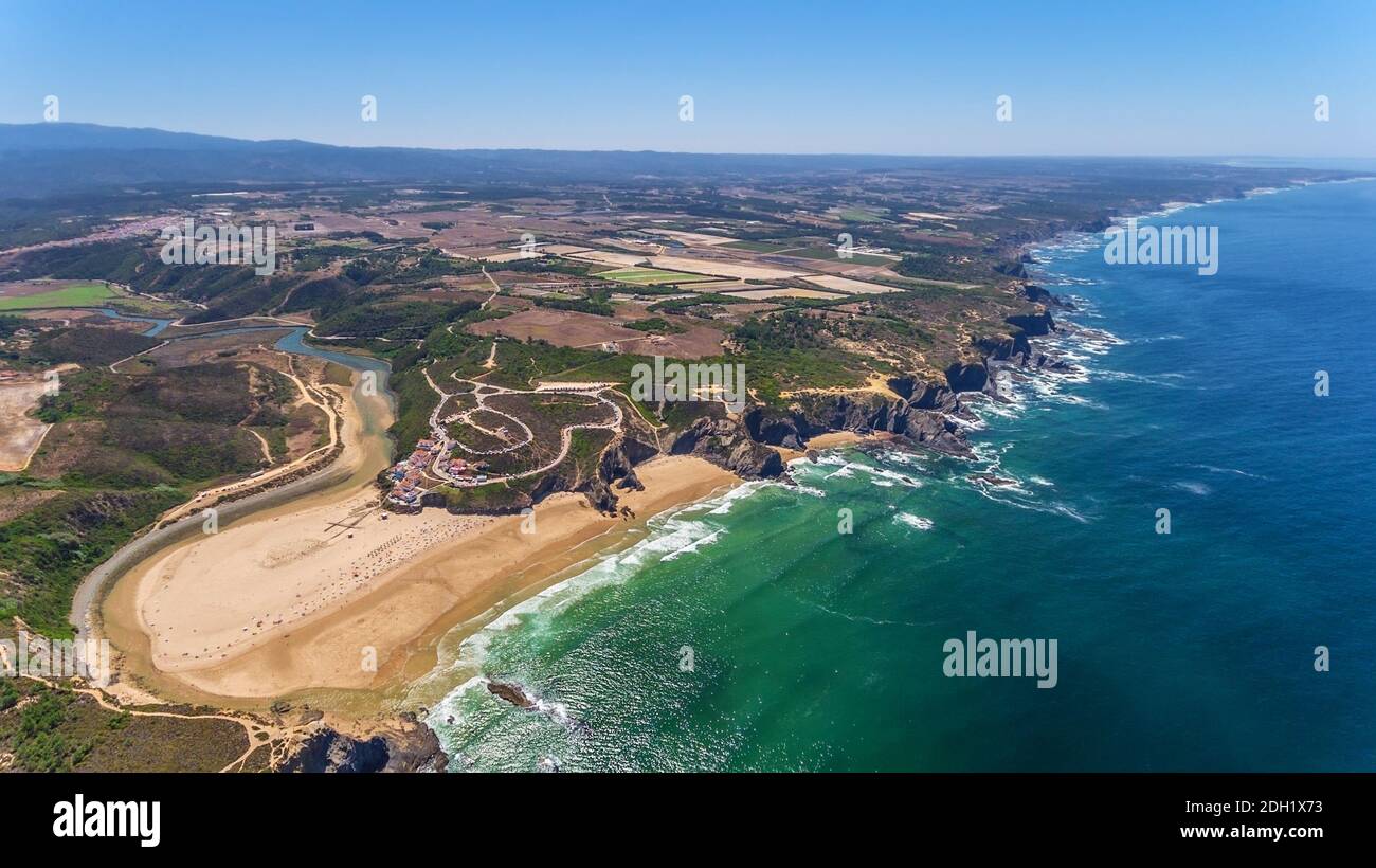 Aerial panorama of the village and Odeceixe beach, in summer overlooking the Algarve. Portugal Stock Photo