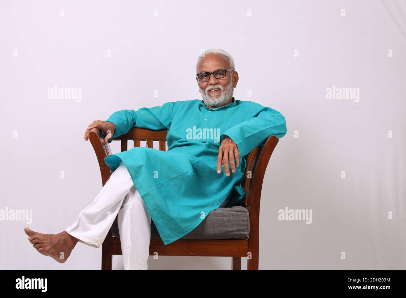 Senior Indian man relaxing or sitting on chair. Stock Photo