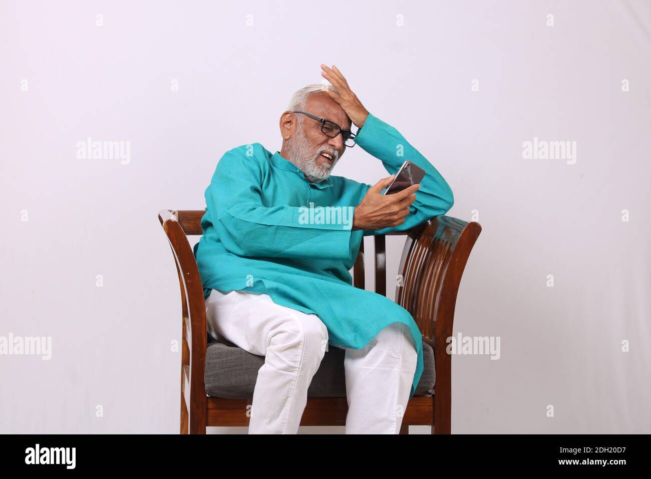 Cool bearded indian old man using mobile phone Stock Photo