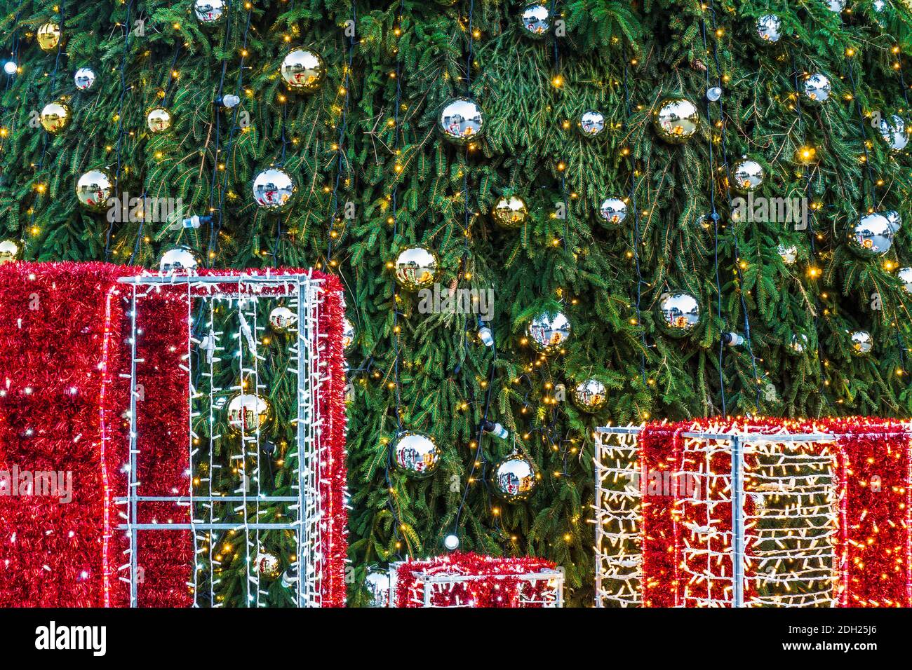 Christmas Tree with Decorations Lights and Gift Boxes Stock Photo