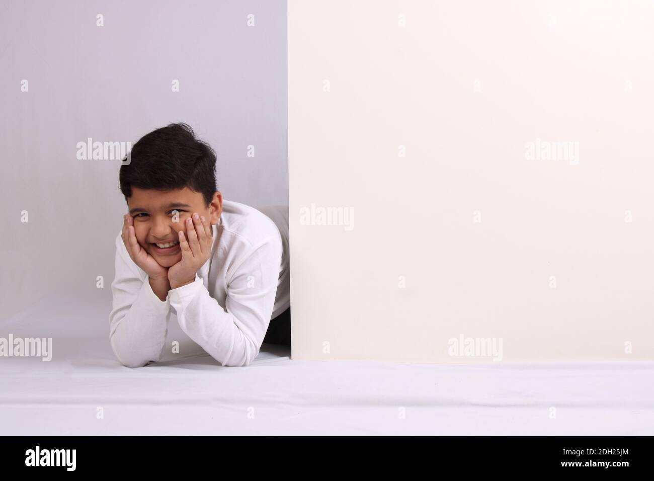 Young Indian schoolboy showing blank copy space. Stock Photo