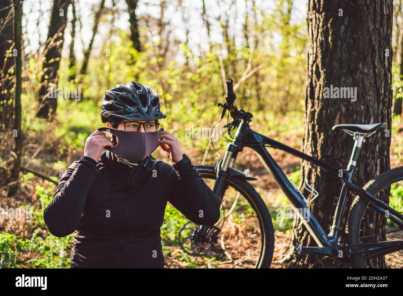 Young woman in protective mask from environmental pollution riding