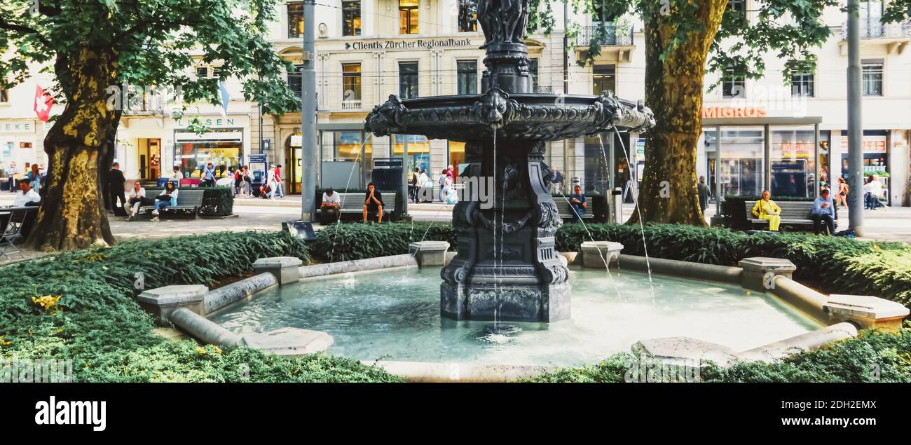 European architecture and fountain in city park in Zurich, Switzerland Stock Photo