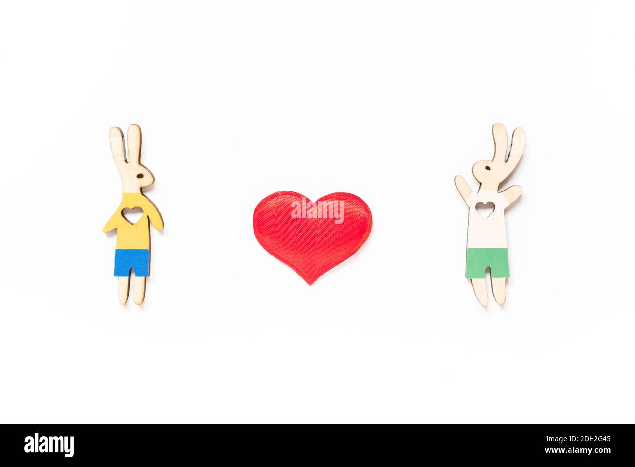 Valentine's day lgbt, love, romantic concept. Couple of rabbits, a boy and a boy, with red heart on white background. Flat lay, top view. Stock Photo