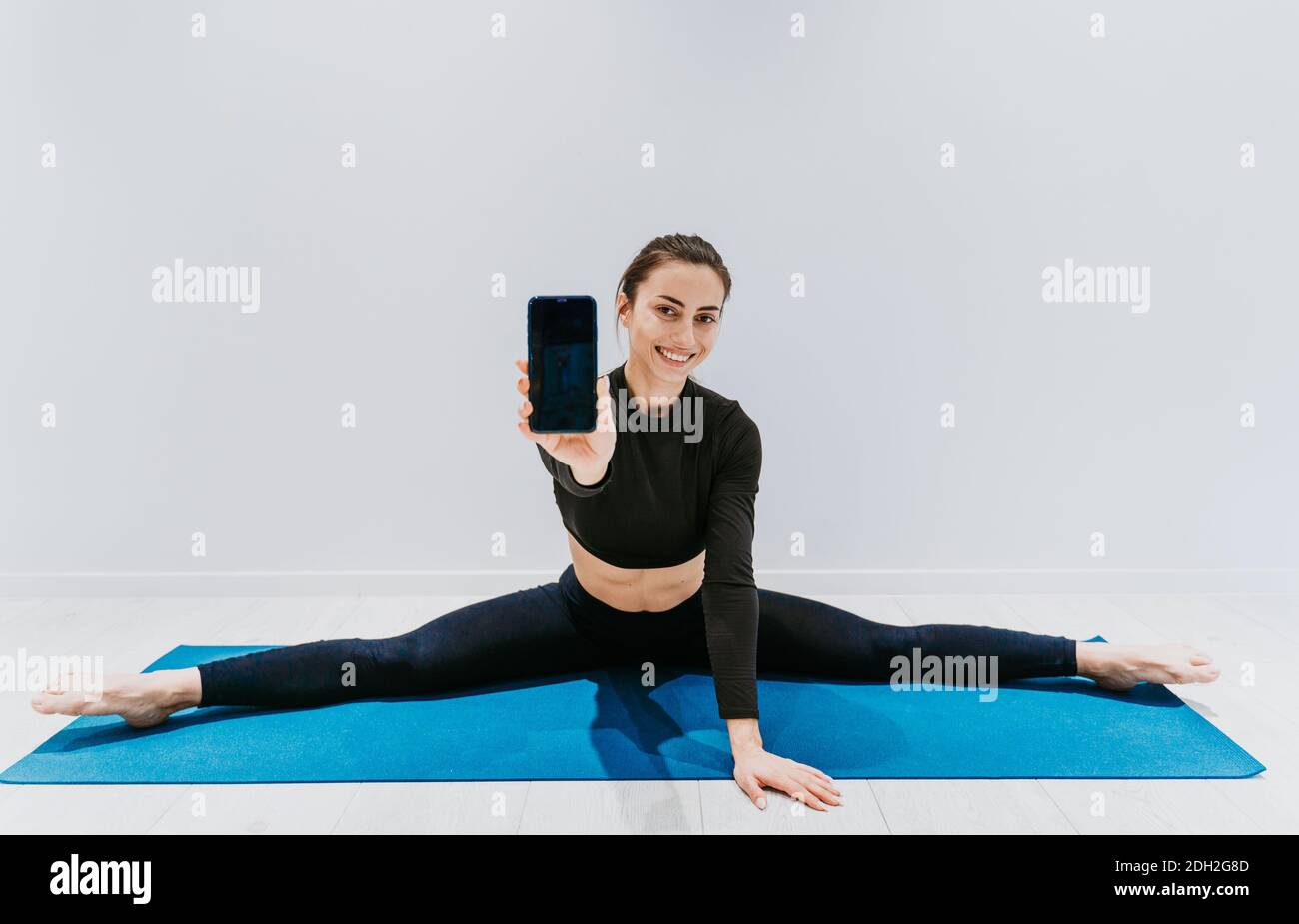Beautiful girl training in the gym. Russian classic dancer doing stretching  and yoga poses Stock Photo - Alamy