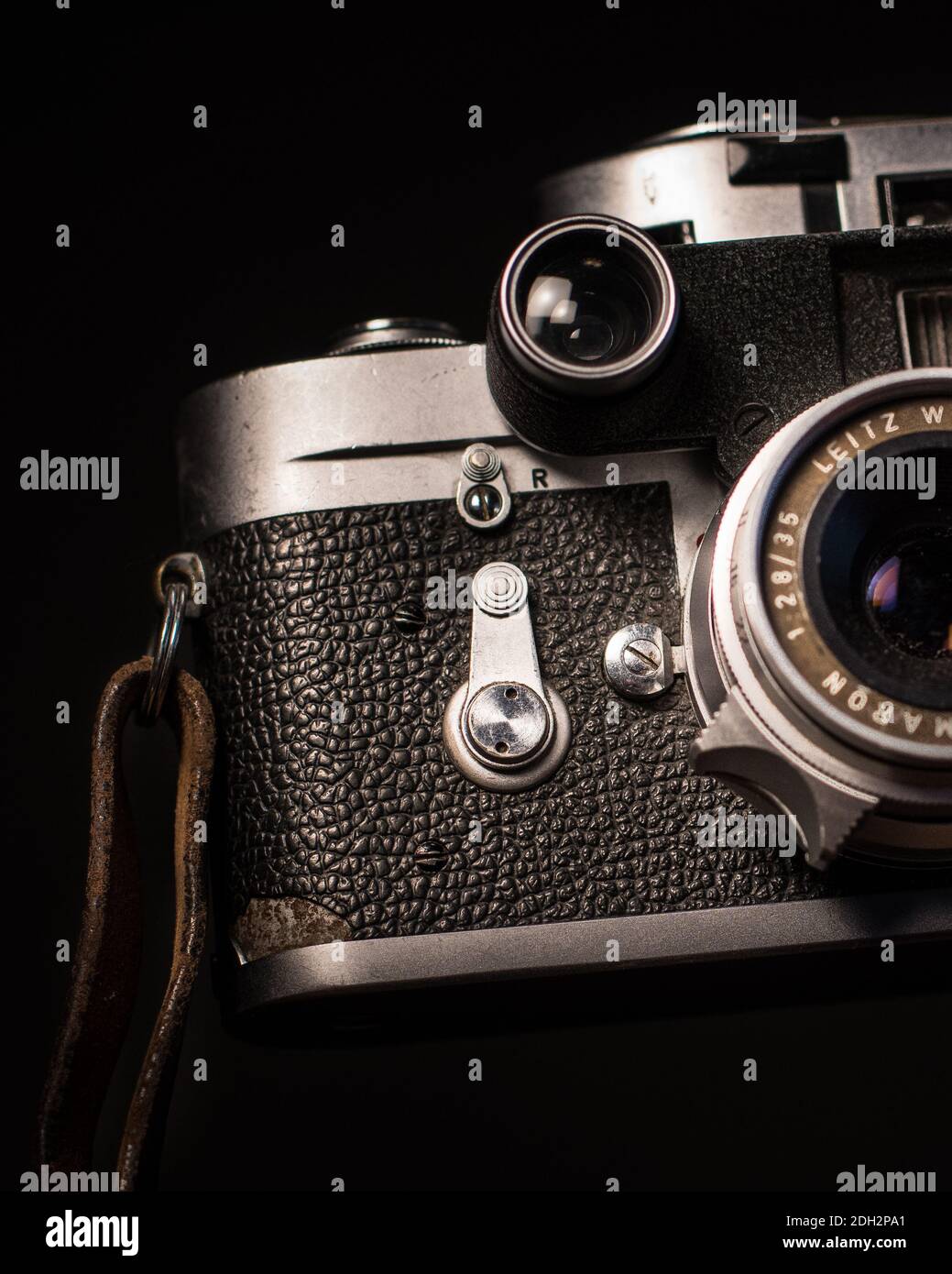 Vintage camera with rollfilm close up, half the camera body and lens