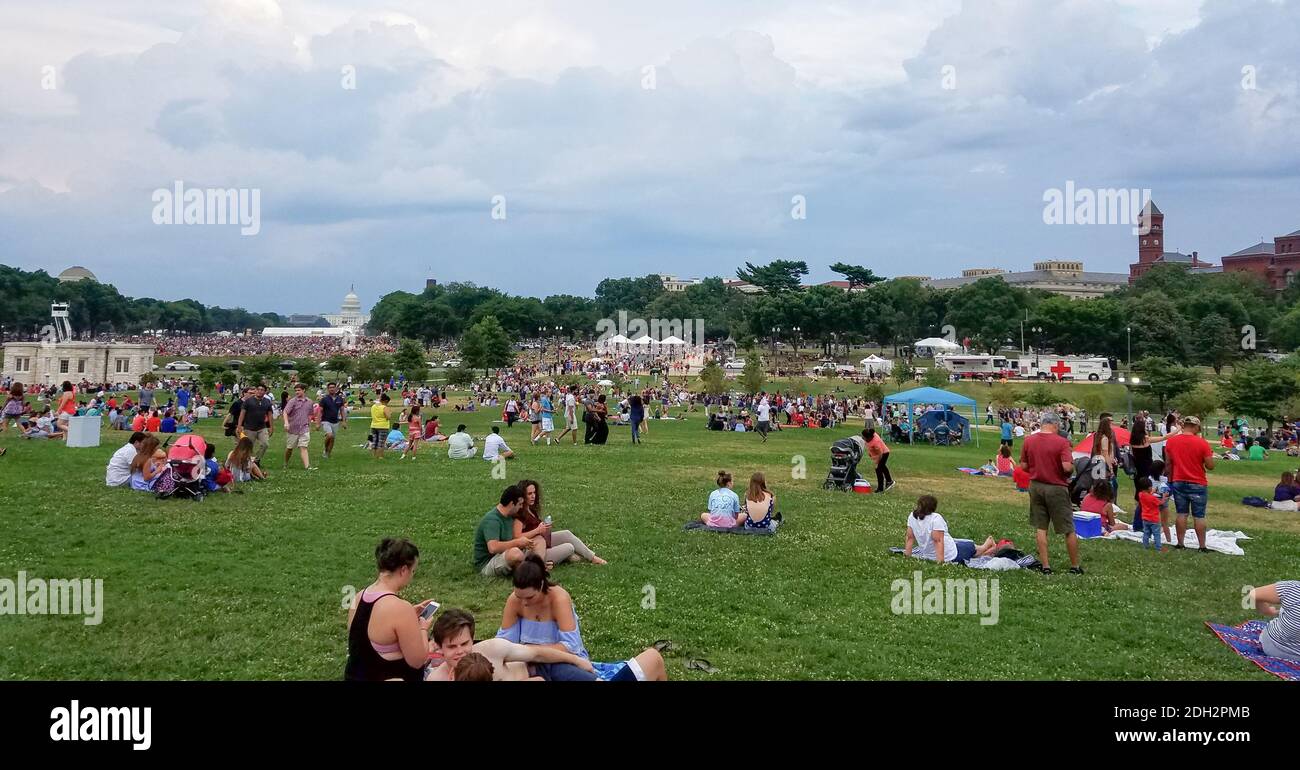 WASHINGTON, DC - JULY 4, 2017: A large crowd waiting for the Independence Day fireworks at the National Mall, looking to the Capitol. Stock Photo