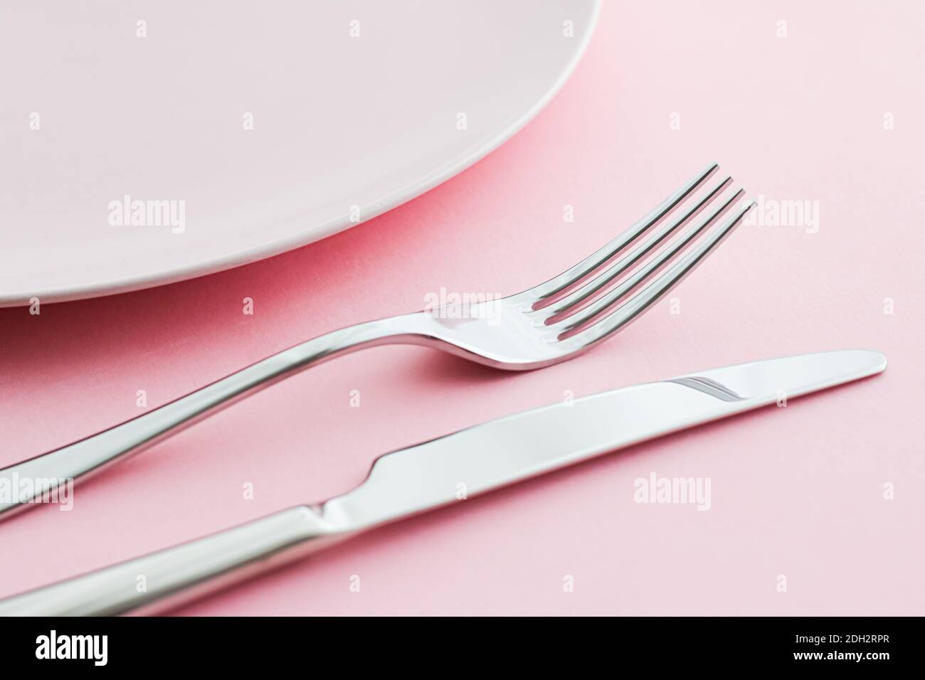 Empty plate and cutlery as mockup set on pink background, top tableware ...