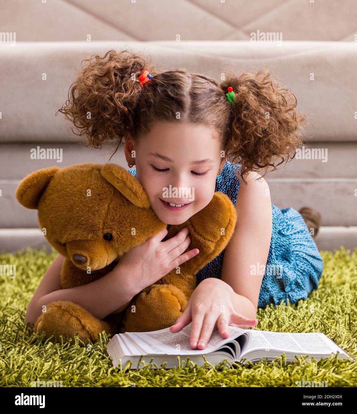 Little pretty girl reading books at home Stock Photo - Alamy