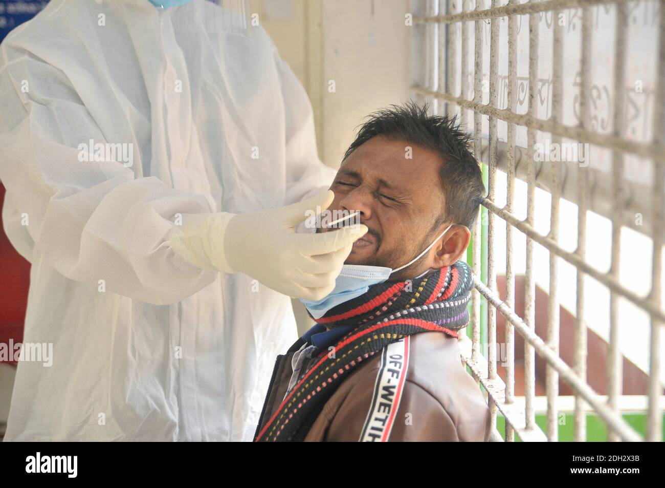 A medical officer wearing a protective kit is collecting samples for
