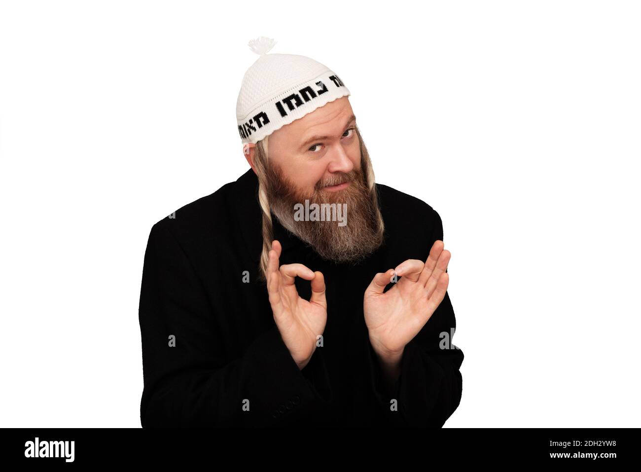Studio portrait of bearded orthodox jewish man. Cheerful smiling charismatic jew with sidelocks in white yarmulke isolated on white background Stock Photo