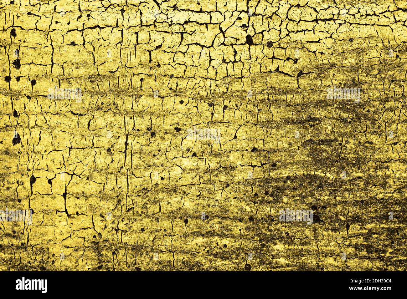 Old cracked Illuminating yellow paint texture. Grunge abstract background. Golden surface. Color