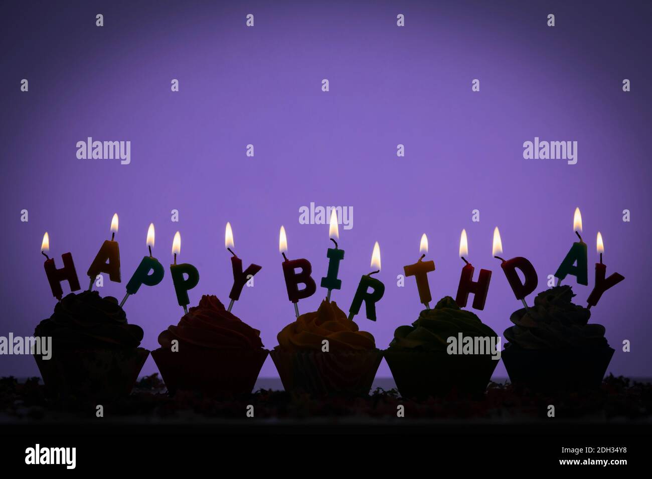 Silhouette of birthday cupcakes in a row Stock Photo