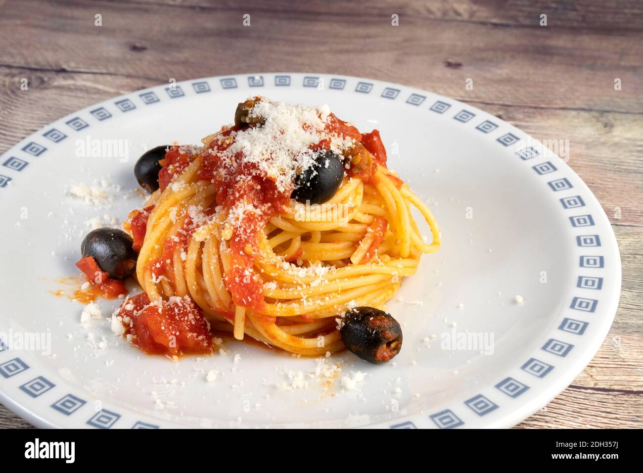 Spaghetti alla Puttanesca, with tomato, olives, capers and anchovies Stock Photo