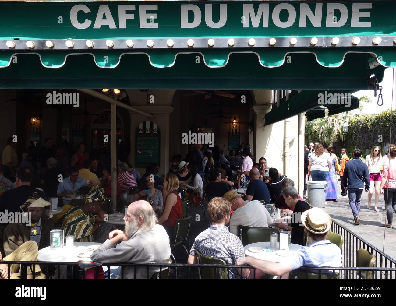 NEW ORLEANS,LA/USA -03-21-2014: People gathered at the famous Cafe Du Monde in New Orleans French Quarter Stock Photo