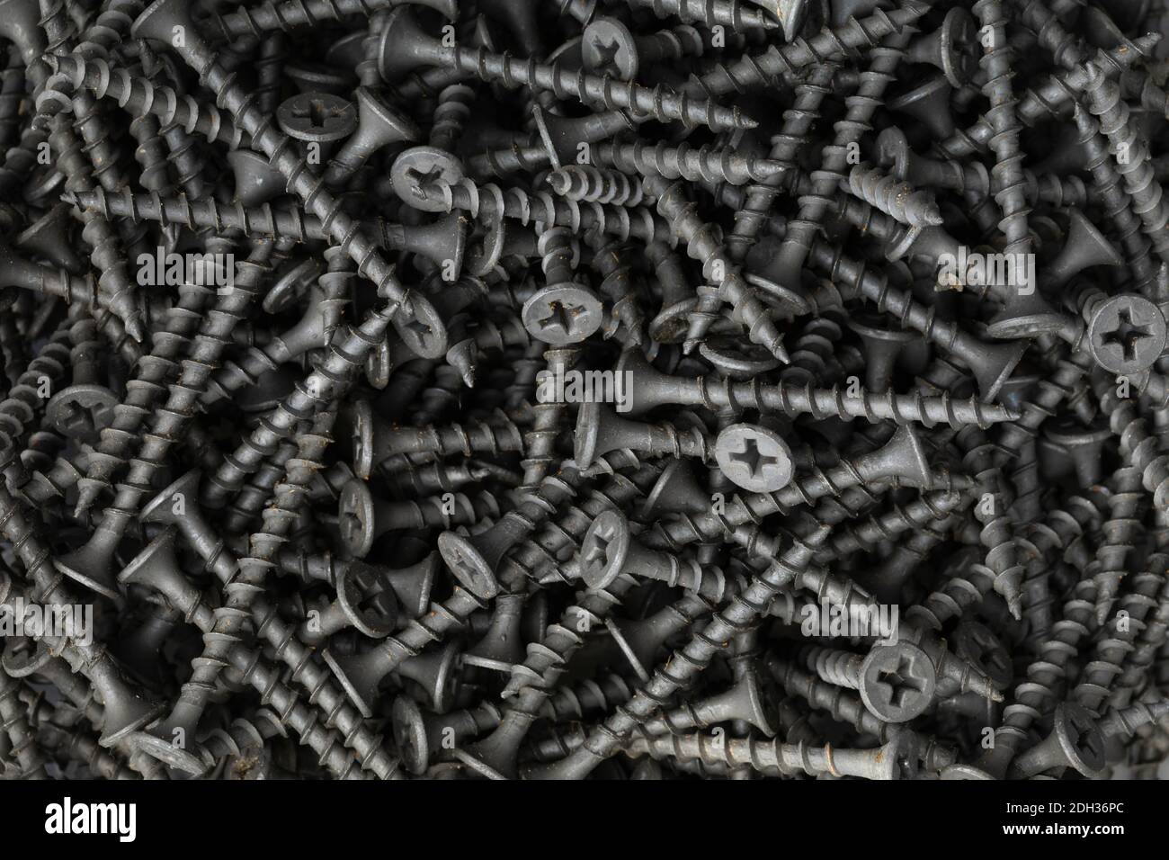 pattern of black construction screws Stock Photo
