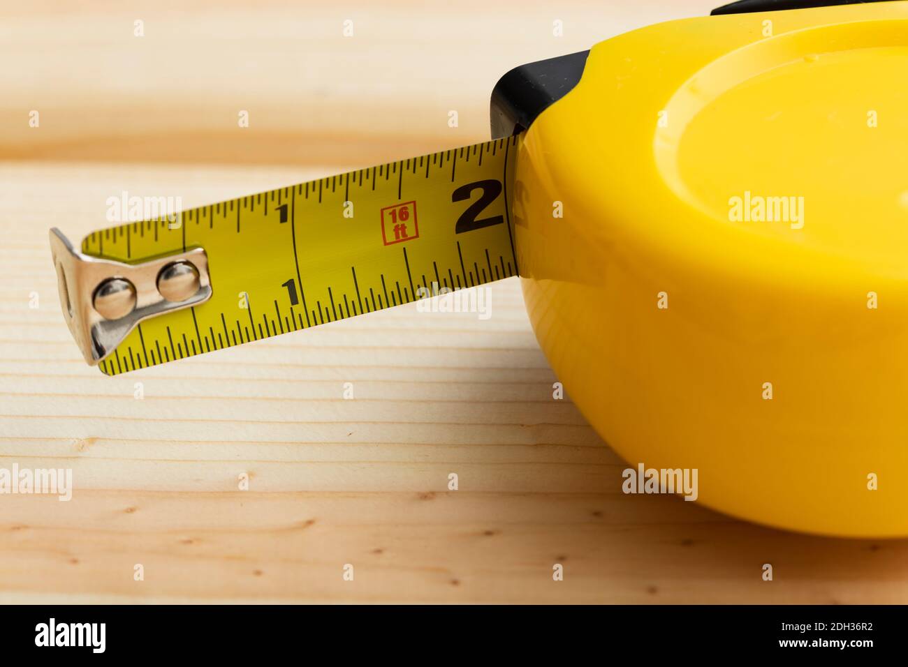 Tape measure laying on wood Stock Photo