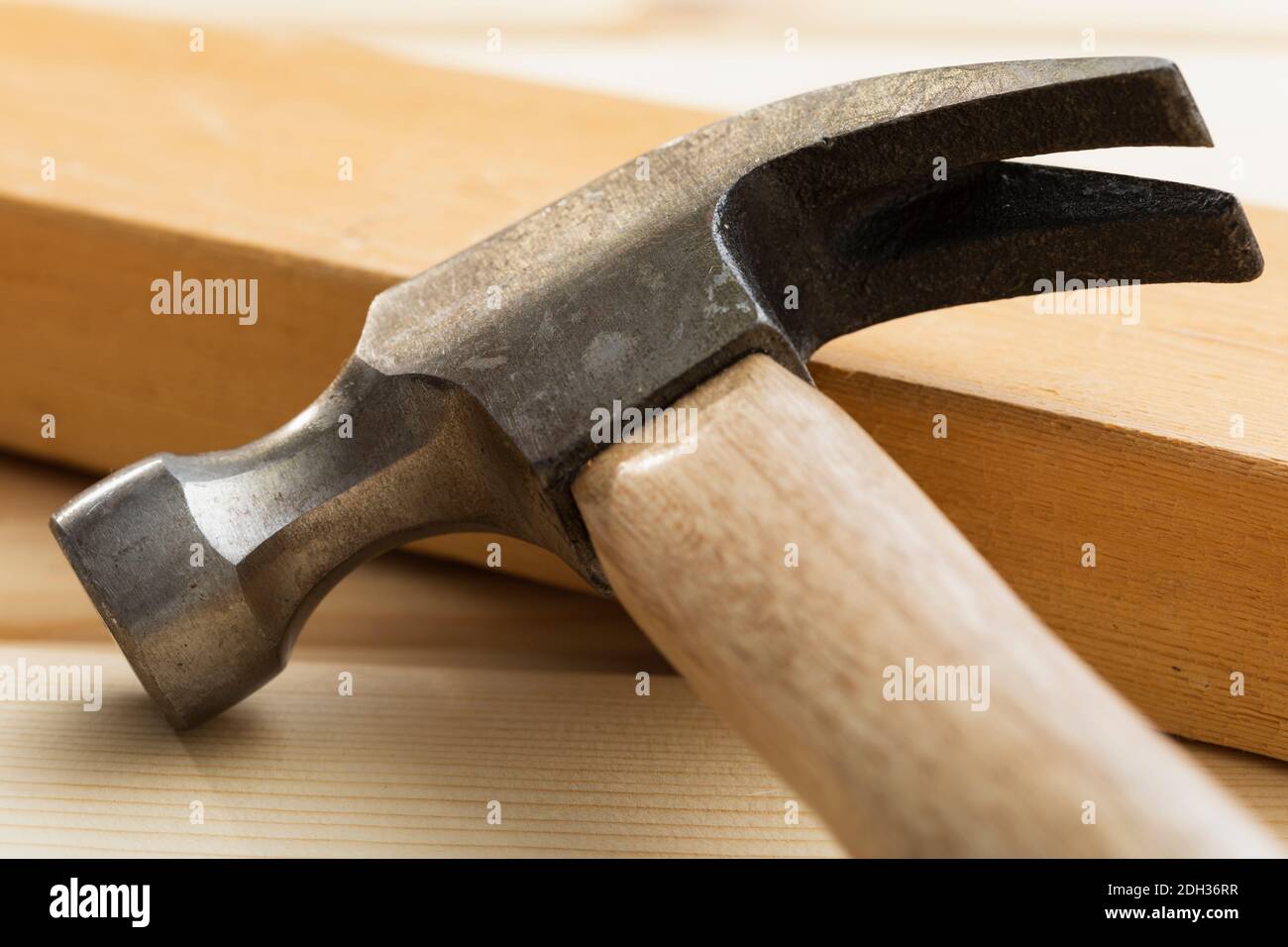 Hammer laying on lumber Stock Photo