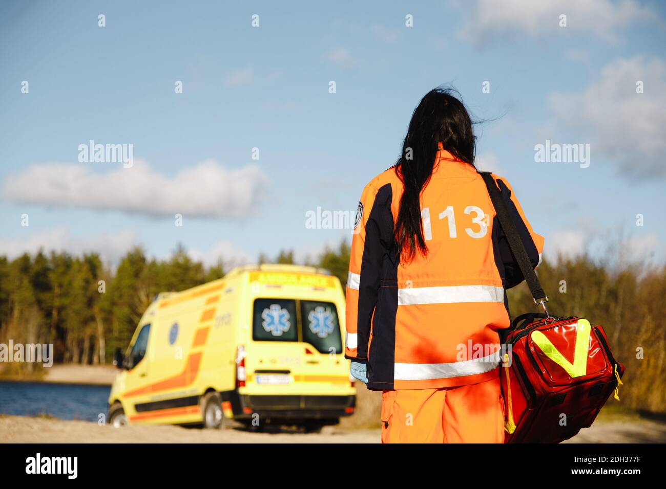 Female paramedic's epic walk towards ambulanca Stock Photo