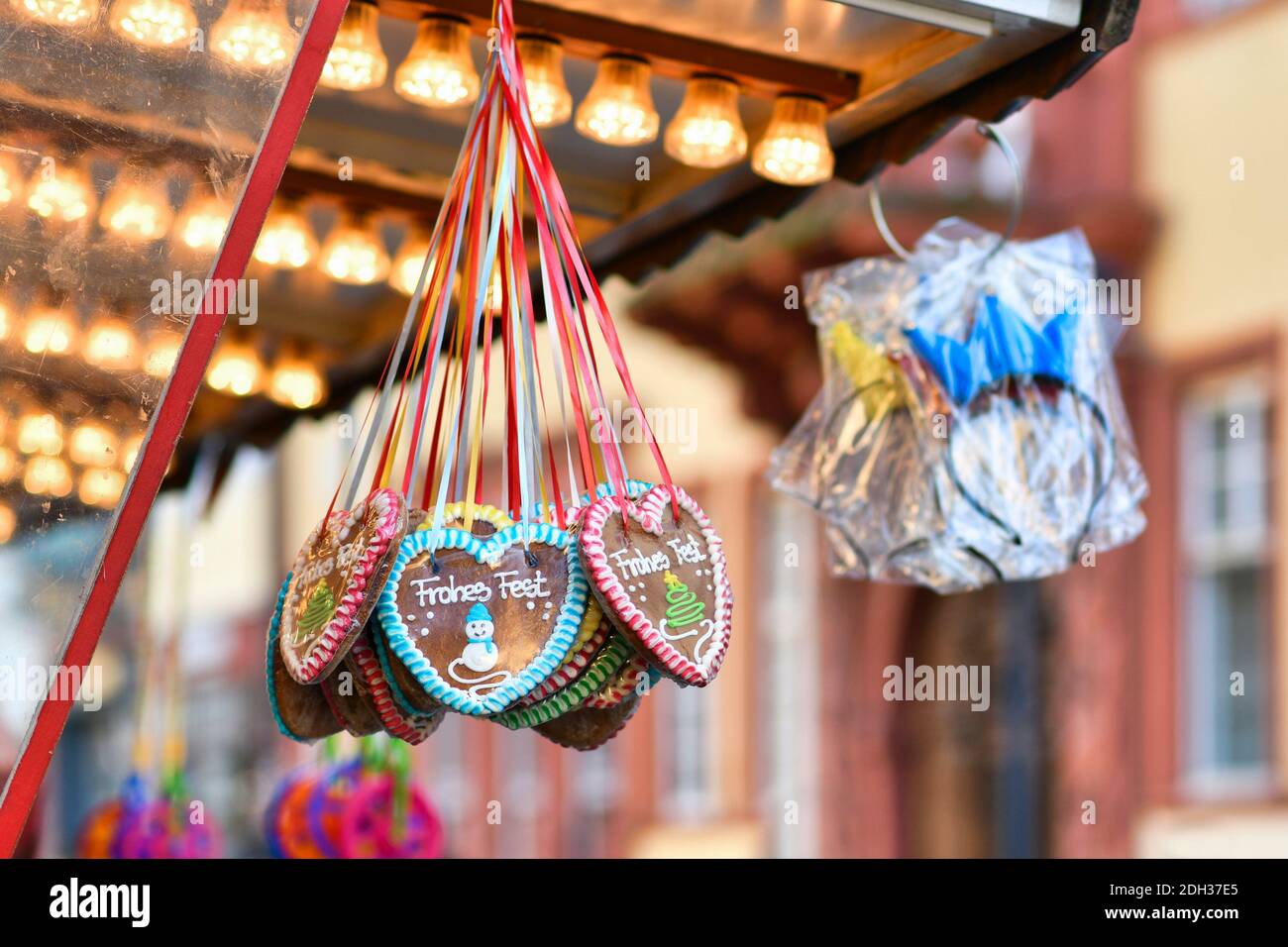 Heidelberg, Germany - December 2020: Heart shaped gingerbread candy with sugar icing and  German text  'Happy Holiday' hanging at Christmas market Stock Photo