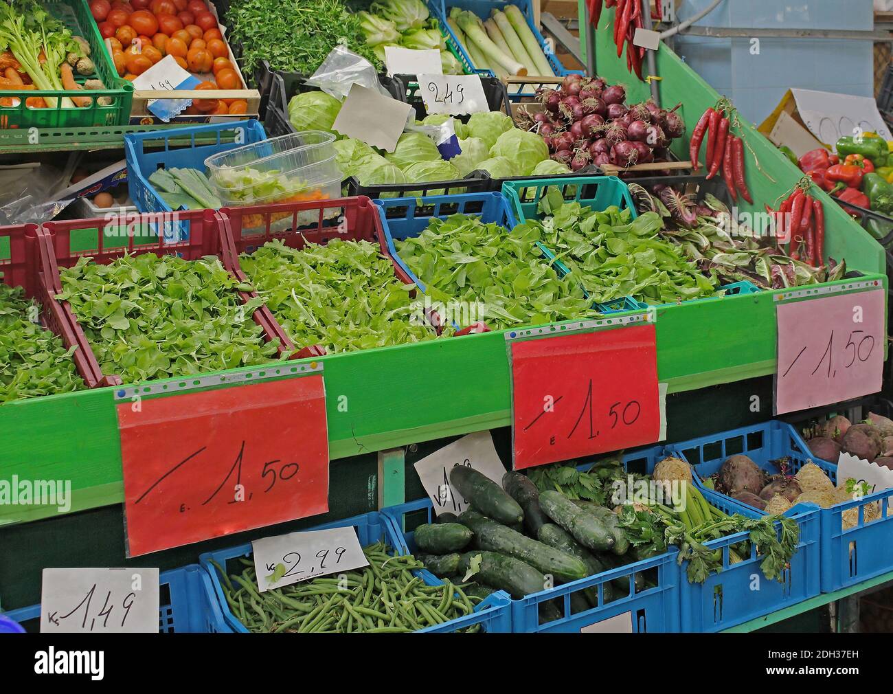 Colorful fresh organic raw vegetables in plastic crates on small market
