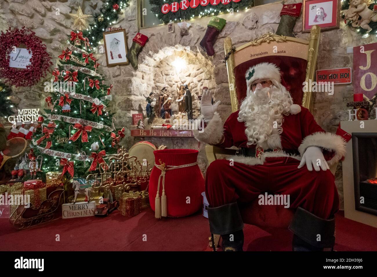 Issa Kassissieh an Arab Orthodox Christian and Israel’s only certified Santa Claus sits at his Santa's House decorated for Christmas in the Christian Quarter old city of Jerusalem Israel Stock Photo