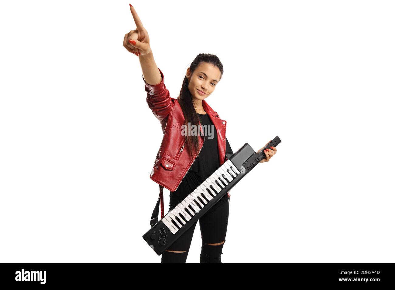 Young woman in a leather jacket with a keytar synthesizer pointing up isolated on white background Stock Photo