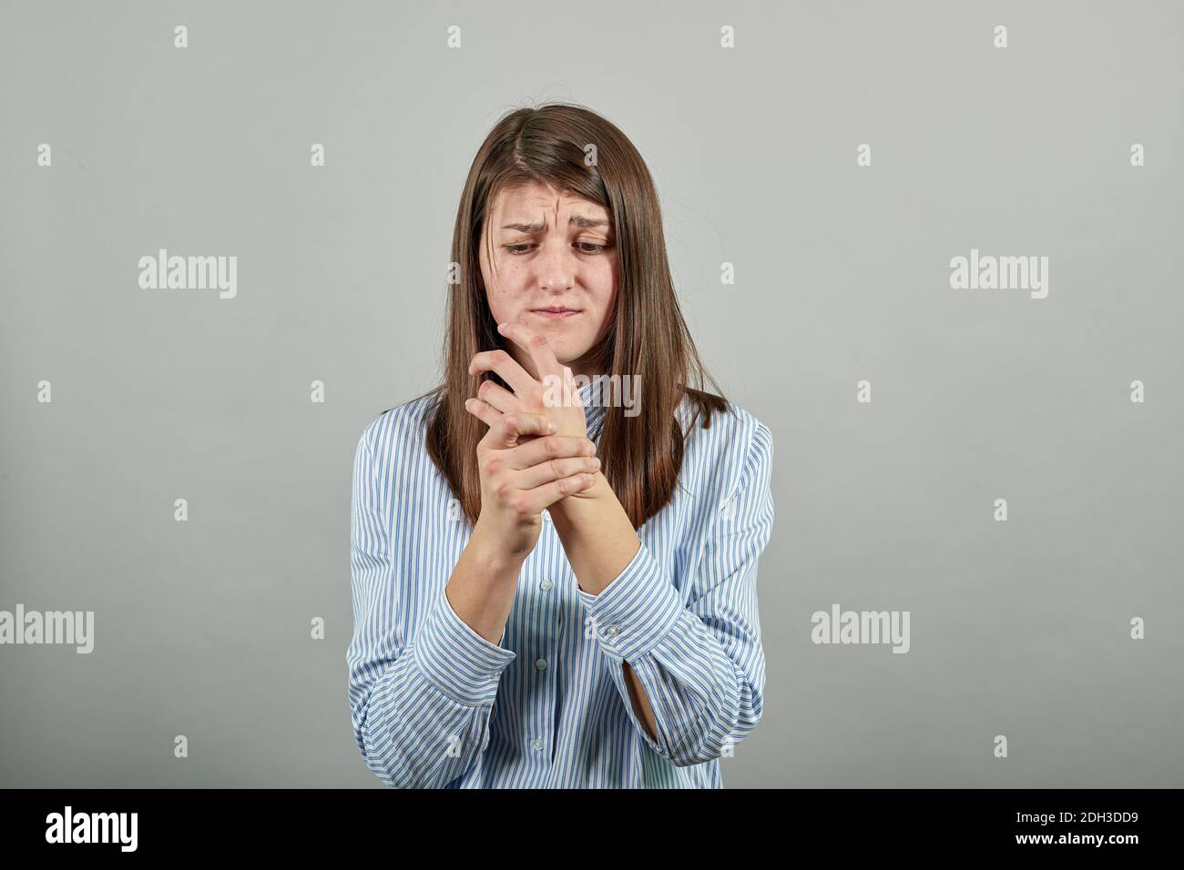 Injured arm injury holds hand, forearm hurts, rubbing hands. Suffering