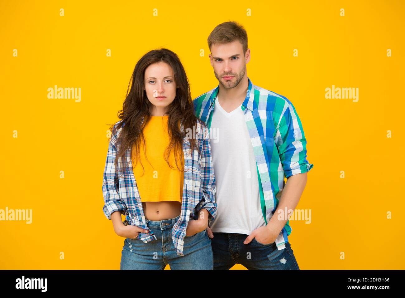 Their style is a lot more casual. Couple in casual wear. Vogue models  yellow background. Fashion clothes. Contemporary streetwear. Trendy  lifestyle. Dont miss our latest trends in clothing Stock Photo - Alamy