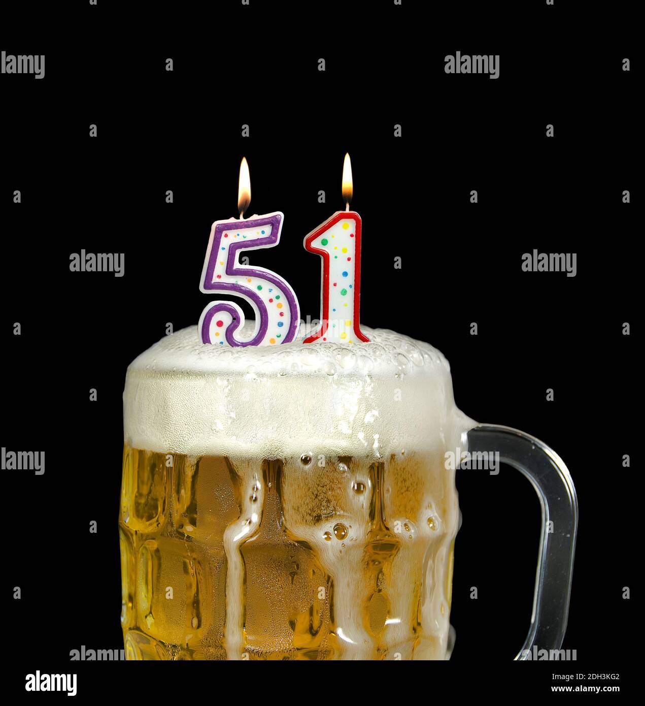 lit number candles in frothy beer mug for 51st birthday isolated on
