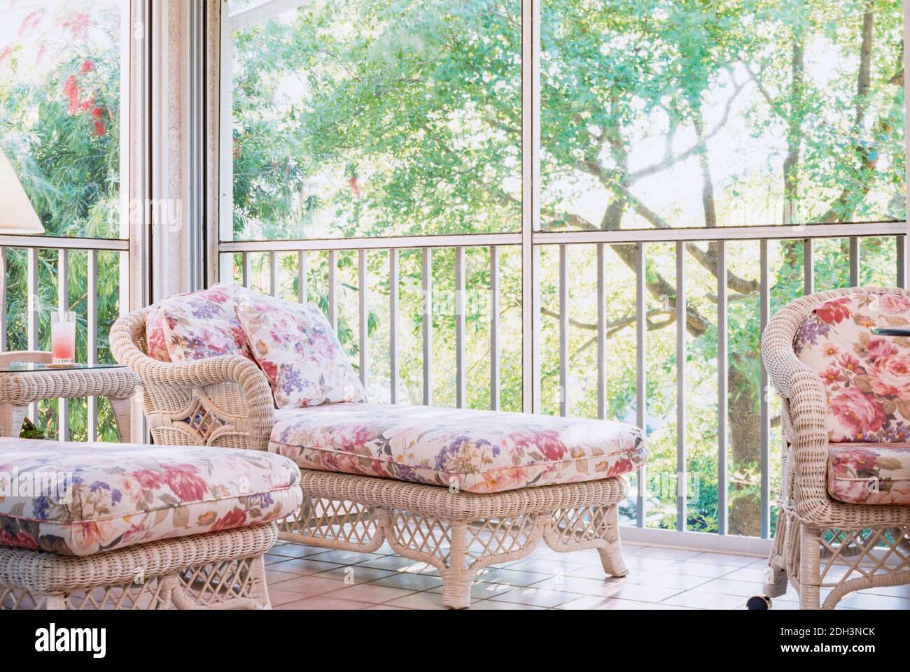 Wicker furniture featured in an enclosed porch in a Florida home, USA Stock Photo