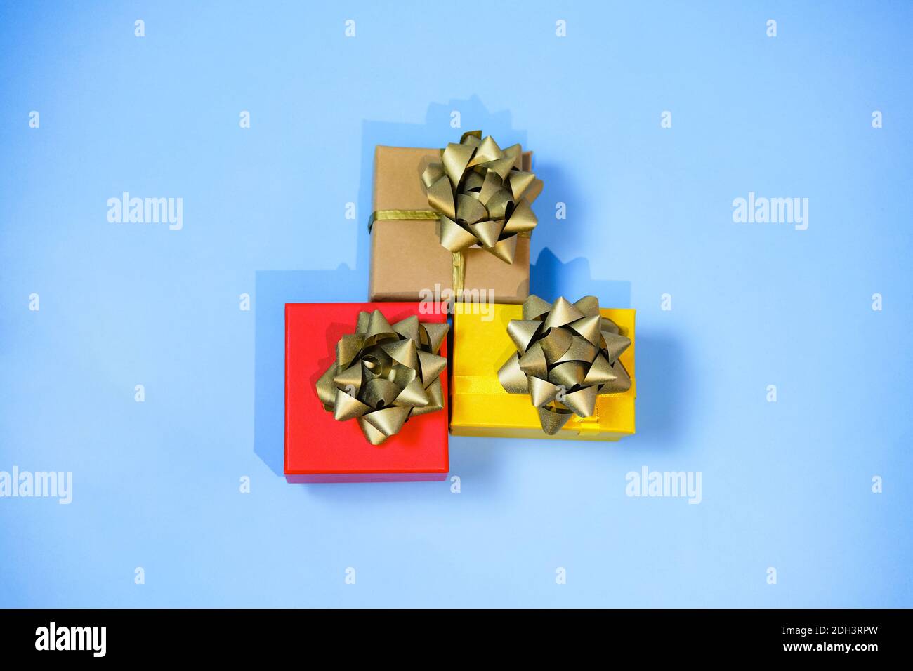 Three colorful presents, red, yellow and craft, with luxury golden ...