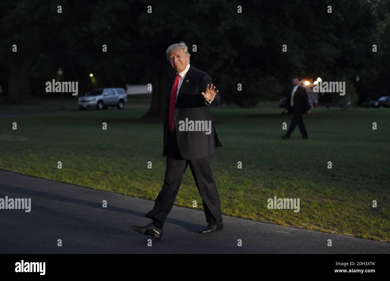 President Donald Trump waves as he returns to the White House on July 8