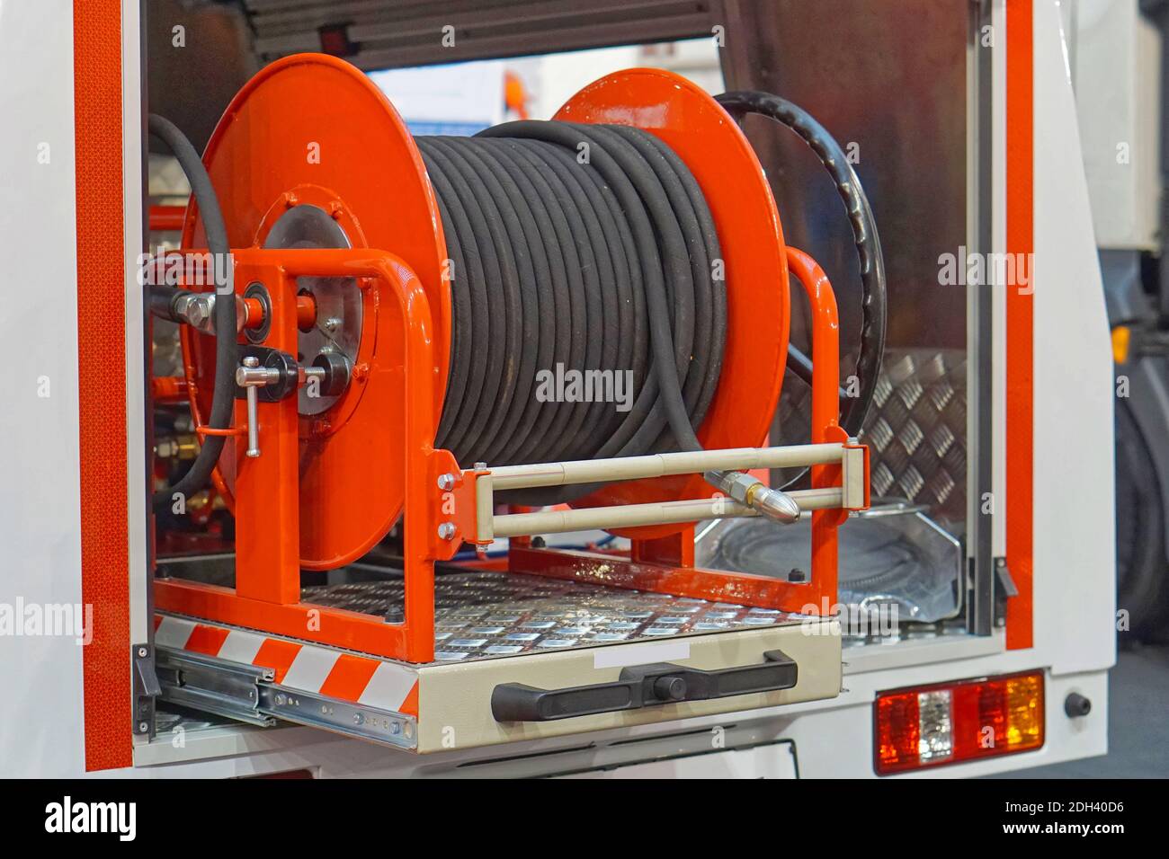 High Pressure fire hose reel at truck engine Stock Photo